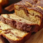 Freshly baked cinnamon bread loaf with a swirl of cinnamon and sugar.