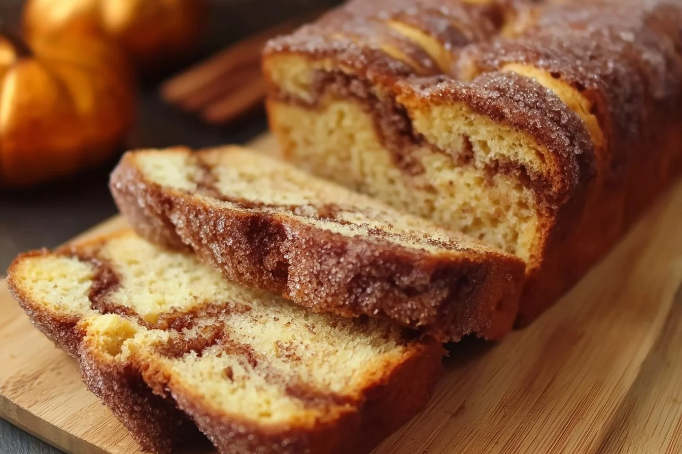 Freshly baked cinnamon bread loaf with a swirl of cinnamon and sugar.