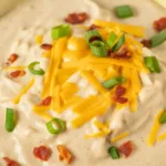Delicious bowl of hashbrown potato soup topped with cheddar cheese and bacon