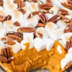 Delicious Sweet Potato Casserole topped with marshmallows and pecans, perfect for Thanksgiving.