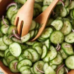 A refreshing cucumber salad with thinly sliced cucumbers and a tangy vinegar dressing.