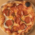 Delicious Hot Honey Pizza topped with pepperoni and cheese, drizzled with spicy honey.