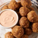 Crispy Boudin Balls served with Creole mustard sauce, a Cajun favorite.