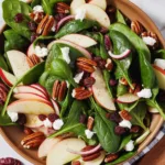 Fresh spinach salad with apples, pecans, and a tangy vinaigrette dressing