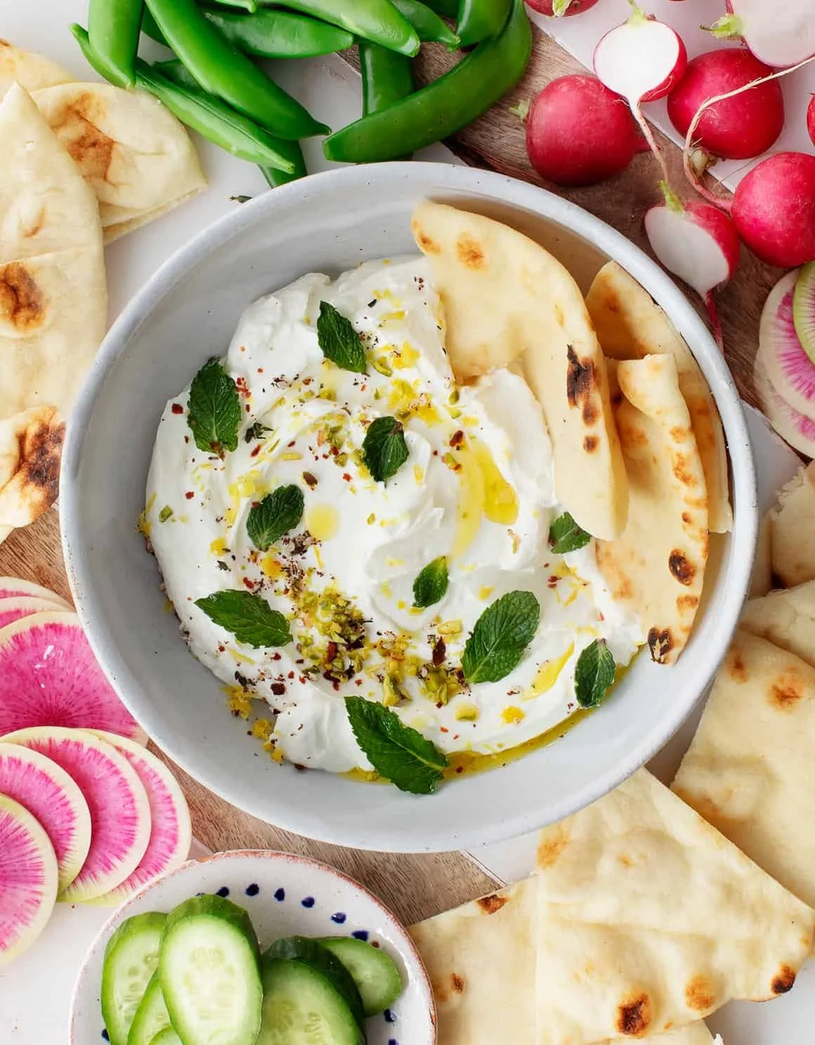 Delicious Labneh served with olive oil and herbs for a Middle Eastern appetizer.