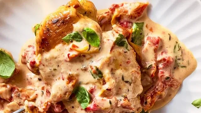 Delicious Marry Me Chicken dish served with vegetables and herbs