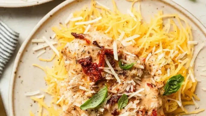 Delicious Crockpot Marry Me Chicken served on a plate with herbs and garnishes