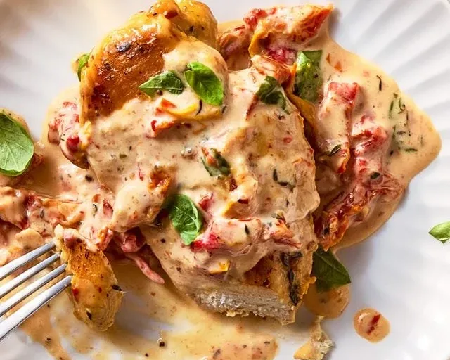 Plate of the Original Marry Me Chicken garnished with herbs