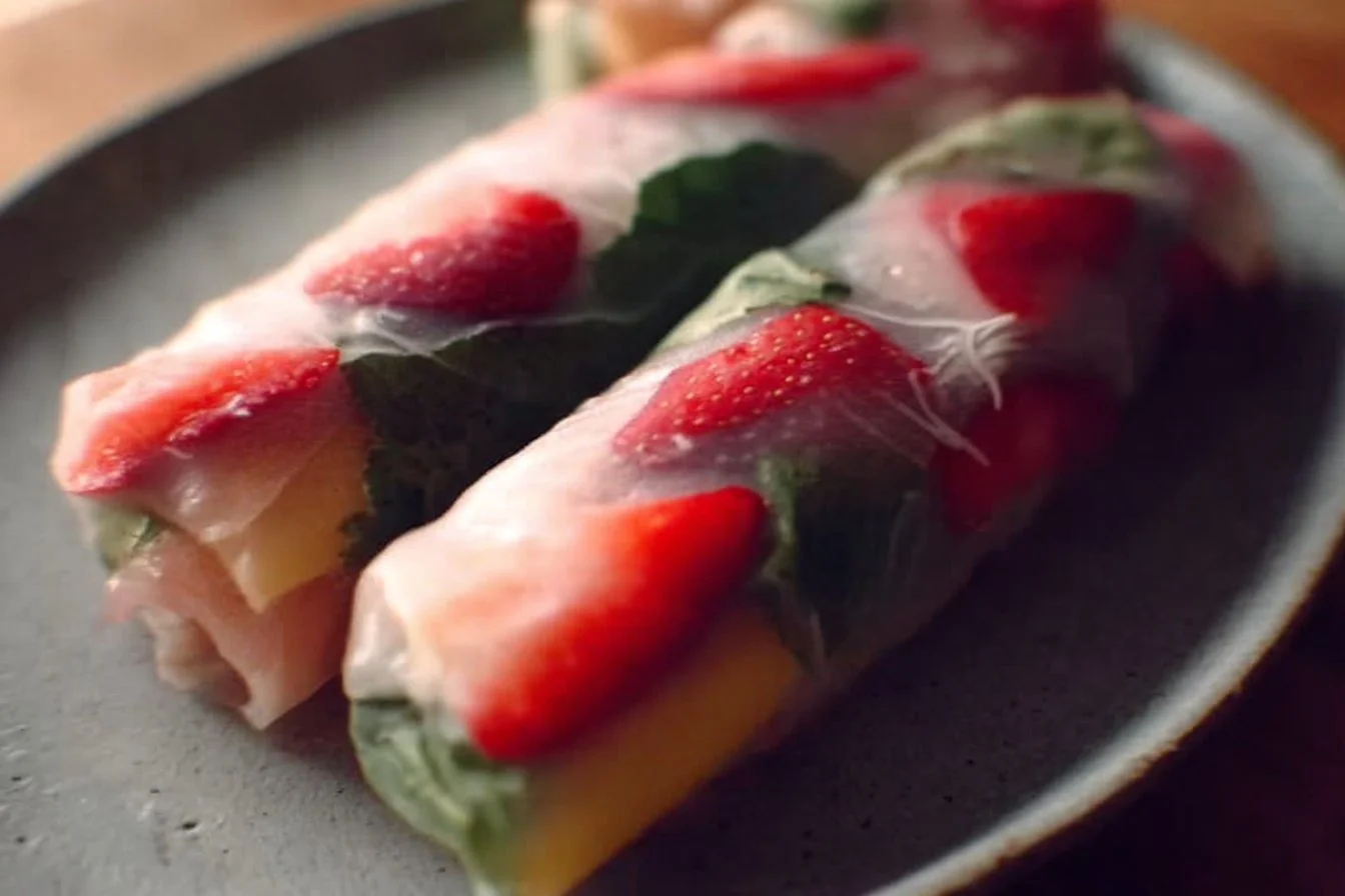Colorful and fresh Fruit Rice Paper Rolls on a plate with dipping sauce