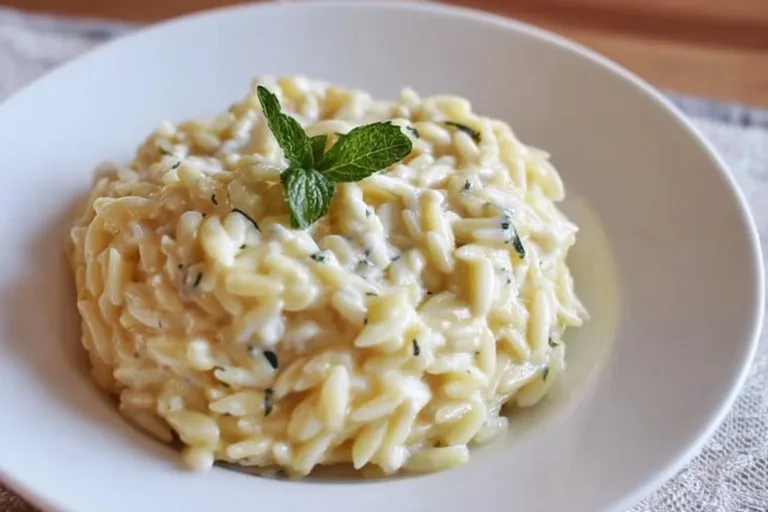 Bowl of protein-packed cottage cheese orzo with fresh herbs and vegetables