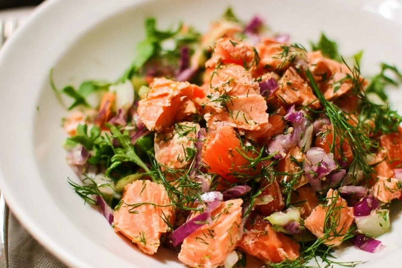 Fresh and healthy salmon salad with mixed greens and colorful vegetables
